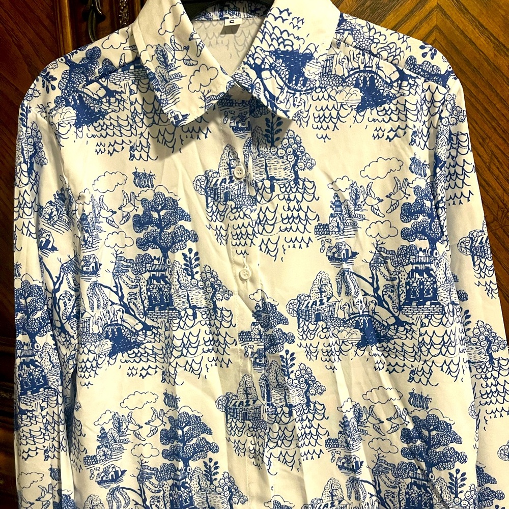 New without tags, blue landscape print button down blouse. Small in size.